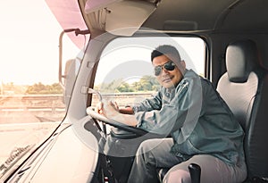 Semi truck driver wearing sunglasses happy smiling