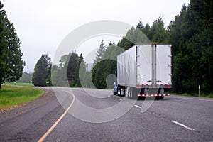 Semi truck with dry van semi truck moving on scenic curvy highway