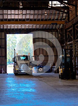 Semi truck entering old antic building warehouse unloading cargo