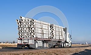 Semi-truck with a load of plastic pipe