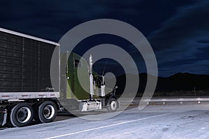 Semi-truck on parking lot in night moonlight