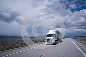 Semi truck with reefer trailer on flat long Arizona road