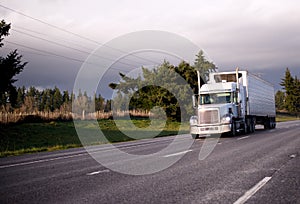 Semi truck with reefer unit and refrigeration trailer on wide hi photo