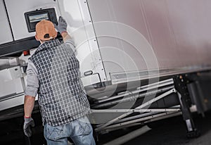 Semi Truck Refrigerated Semitrailer Cargo Temperature Check Performed by a Driver photo