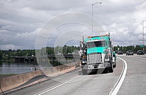 Semi truck rig driving on long bridge across Columbia River