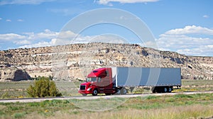 Semi-truck on the road in the desert