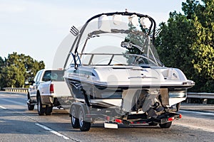 Semi-truck towing a boat on the interstate, California