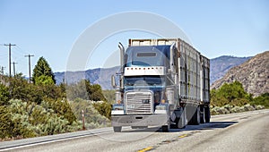 Semi truck with trailer driving on highway