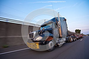 Semi Truck with trailer inscription overload at speed on highway