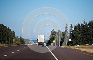 Semi truck with semi trailer running away by straight highway