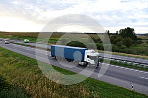 Semi Truck transport the Shipping container on highway. Shipping Containers Delivery, Maritime Services and Transport logistics