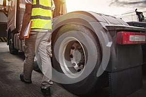 Semi Truck Wheels Tires. Truck Drivers Checking the Truck's Safety of Truck Wheels. Work Shop