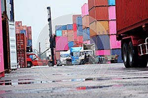 Semi-trucks and container lifters in the container yard