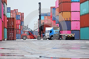 Semi-trucks and container lifters in the container yard