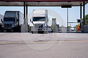 Semi Trucks are at the gas station for refueling