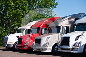 Semi trucks models in row on truck stop parking lot