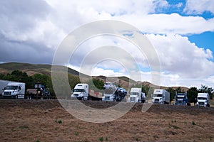 Semi trucks stop in row on California rest area