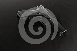 A semiautomatic pistol on a black background