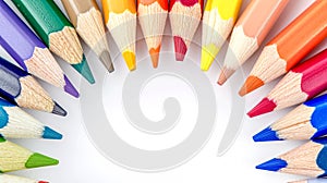 semicircle of sharpened colored pencils with tips pointing inward, displaying a spectrum of colors against a bright
