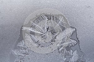 Semicircular fragment of winter frosty pattern on frozen window.