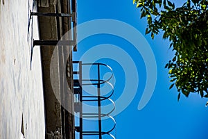 Semicircular metal pompier ladder on the facade of the building photo