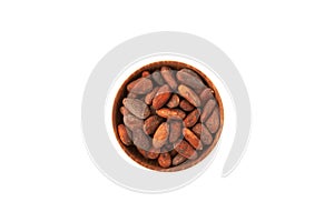 Semillas de Cacao tostadas. Roasted cocoa beans in wooden bowl on white background, top view, copy space photo