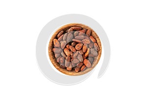 Semillas de Cacao tostadas in wooden bowl on white background, top view photo
