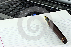 Pen, notepad and keyboard photo