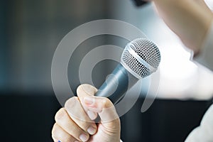 Seminar Speaking Conference Concept : Microphone of speech in seminar room or speaking conference hall light bokeh background.