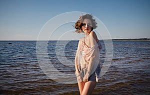 Seminude woman against sea background