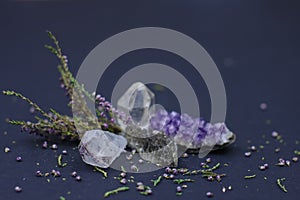 Semiprecious stones: amethyst, rhinestone, smoky quartz and heather branch on a dark background