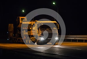 Semitrailer Transport the Excavator along the Night Highway