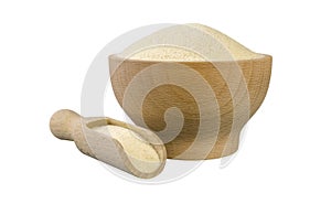 Semolina in wooden bowl and scoop isolated on white background. nutrition. bio. natural food ingredient.front view