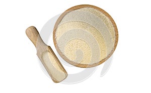 Semolina in wooden bowl and scoop isolated on white background. nutrition. bio. natural food ingredient.top view