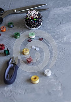 A sempstress inventory: buttons, needles, threads and scissors