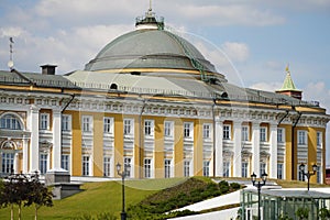 The Senate Palace in the Kremlin against the background of white clouds on a clear sunny day, Moscow