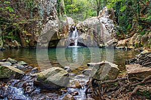 Sendero Rio De La Miel. Small waterfall in the nature, rocks in the foreground.