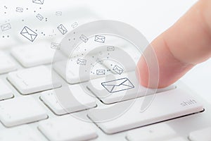 Sending email. gesture of finger pressing send button on a computer keyboard. photo
