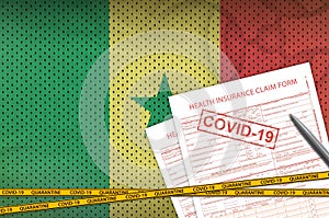 Senegal flag and Health insurance claim form with covid-19 stamp. Coronavirus or 2019-nCov virus concept