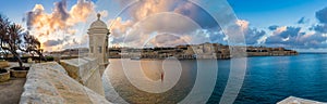 Senglea, Malta - Sunset and panoramic skyline view at the watch tower of Fort Saint Michael, Gardjola Gardens with beautiful sky