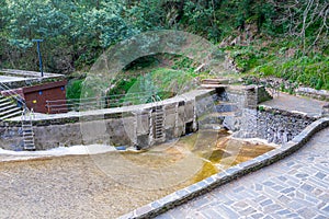 Senhora da Piedade river beach with little water, open floodgates in Serra da LousÃÂ£, Portugal. photo