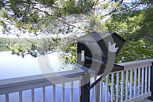 Senic view of a bird house on a calm, reflctive lake photo