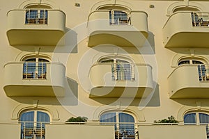 Senigallia, Italy: Yellow facade of the modern building with lines of balconies with windows