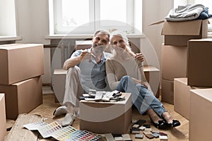 Senior 60s married couple enjoying moving into new apartment