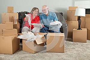 Senior Adult Couple Packing or Unpacking Moving Boxes