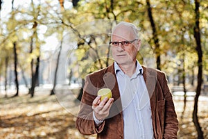 Senior adult holding green apple