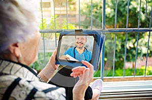 A senior adult patient connects with a telemedicine doctor through an application.