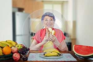 Senior adult woman eating bananas with pleasure