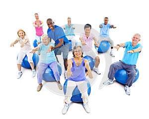 Senior Adults Exercising Yoga With The Instructor