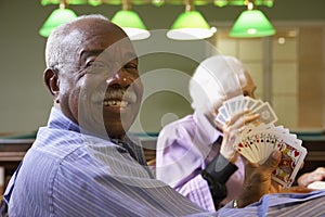 Senior adults playing bridge